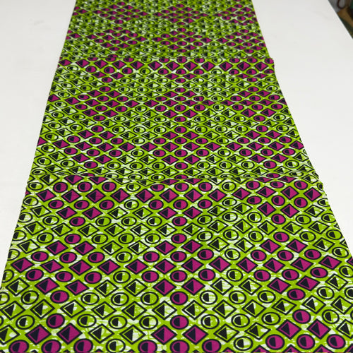 Green and purple geometric patterned fabric on a white background