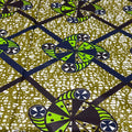 Patterned fabric with green and black geometric design on a textured background