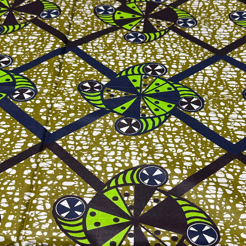 Patterned fabric with green and black geometric design on a textured background