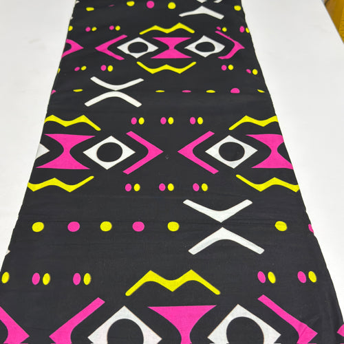 Black fabric with colorful geometric pattern on a white background