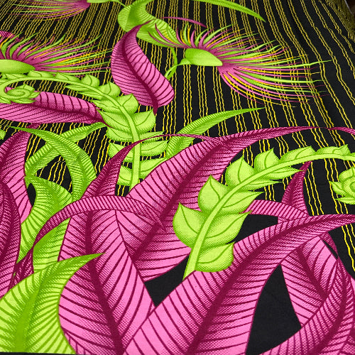 Colorful fabric pattern with pink and green leaves on a black background