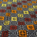 Patterned fabric with geometric shapes in black, yellow, and brown on a black background
