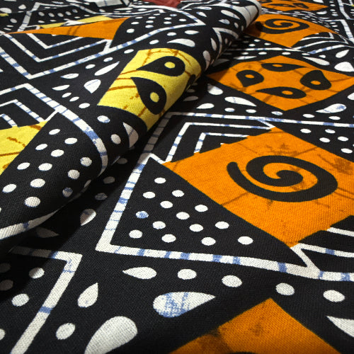 Close-up of patterned fabric with geometric shapes and colors.