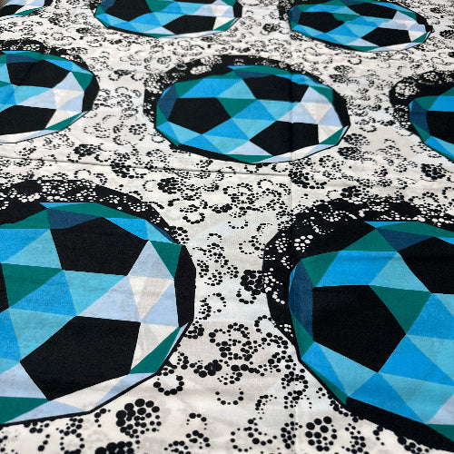 Geometric pattern with blue and black shapes on a textured background
