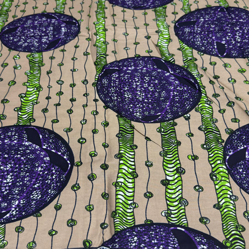Patterned fabric with purple and green design on a beige background