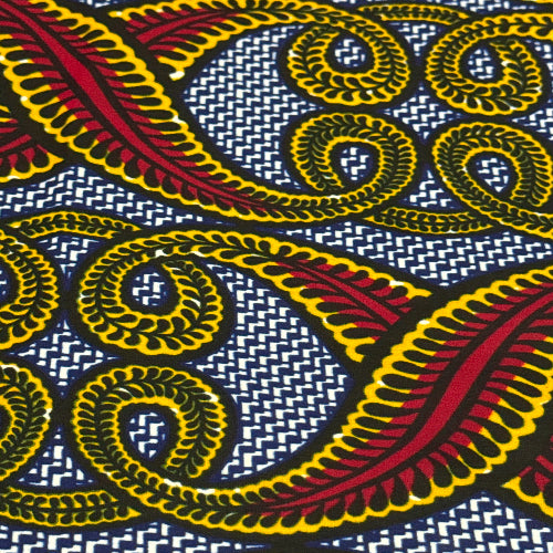 Close-up of a vibrant fabric pattern with yellow, red, and black swirls on a blue and white background.