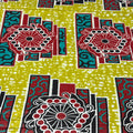 Colorful fabric pattern with geometric shapes and circles on a green background