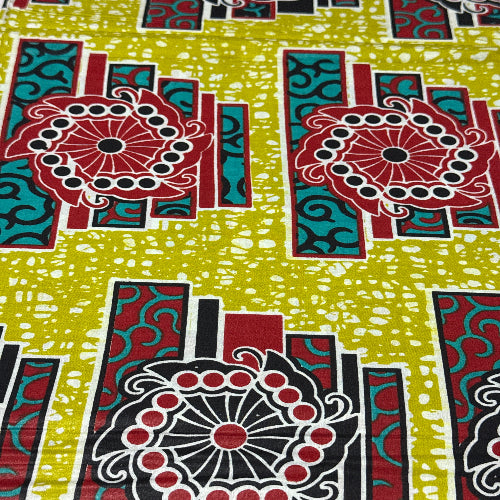 Colorful fabric pattern with geometric shapes and circles on a green background