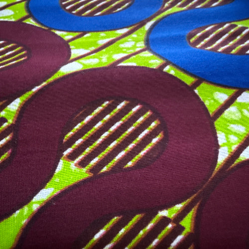 Close-up of fabric with large letters 'S' and 'O' on a multicolored background