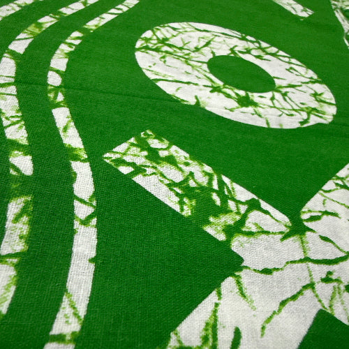 Green fabric with white abstract patterns