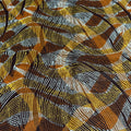 Close-up of a patterned fabric with brown, yellow, and black colors.