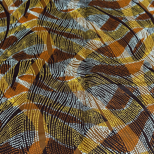 Close-up of a patterned fabric with brown, yellow, and black colors.
