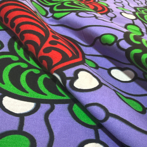 Close-up of colorful fabric with abstract patterns on a purple background