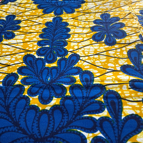 Close-up of blue floral pattern on yellow fabric