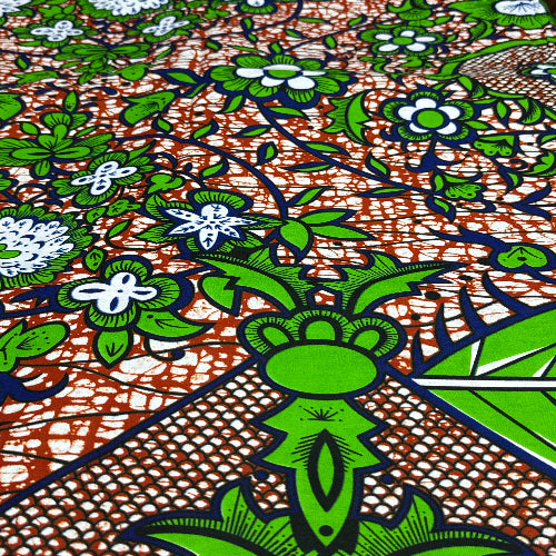 Close-up of a vibrant fabric pattern with green, blue, and brown colors.