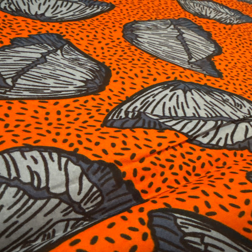 Pattern of gray leaves on an orange background with black dots