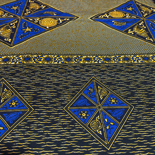 Patterned fabric with blue and gold geometric designs on a textured background