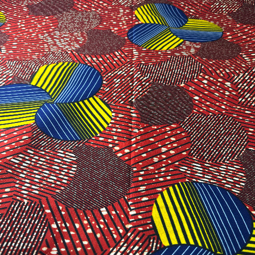 Colorful geometric pattern with blue, yellow, and red shapes on a textured background