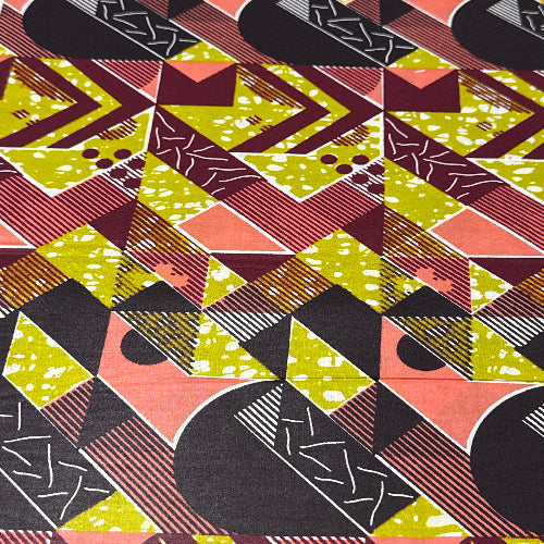 Geometric patterned fabric with a mix of colors including green, pink, black, and brown.