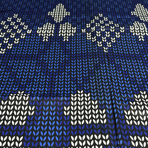 Patterned fabric with white geometric shapes on a blue background
