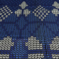 Patterned fabric with white geometric shapes on a blue background