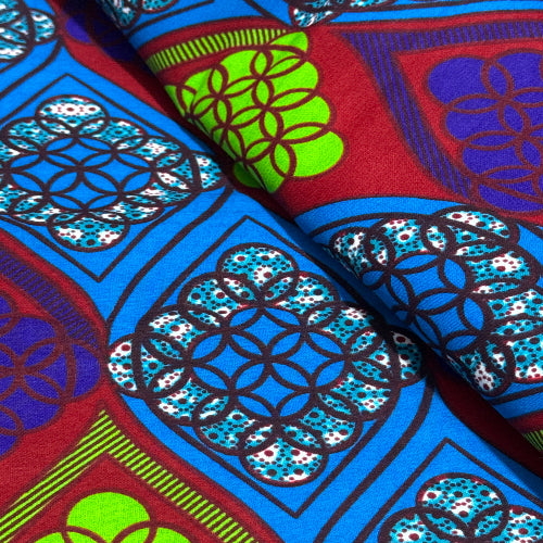 Close-up of colorful fabric with geometric patterns in red, blue, green, and black.