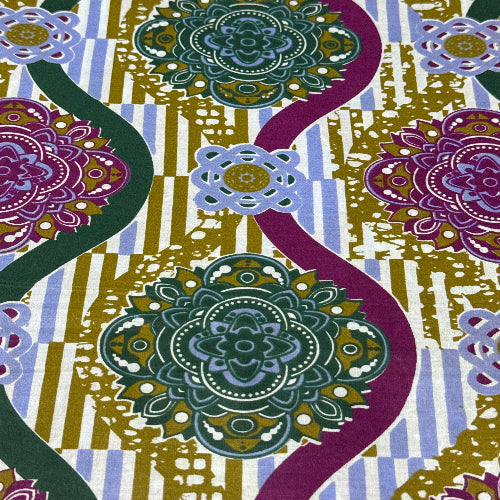 Colorful patterned fabric with geometric shapes and floral elements.