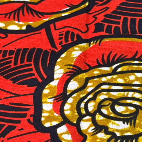 Close-up of fabric with black floral pattern on red and gold background