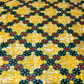 Patterned fabric with black, red, and white flowers on a yellow background
