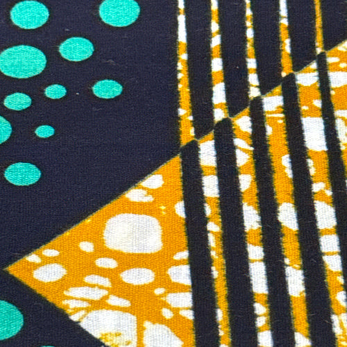 Close-up of fabric with geometric pattern including triangles and circles.