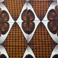 Patterned fabric with brown and black geometric design on a white background