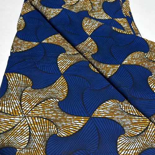 Folded fabric with blue and gold leaf pattern on a white background