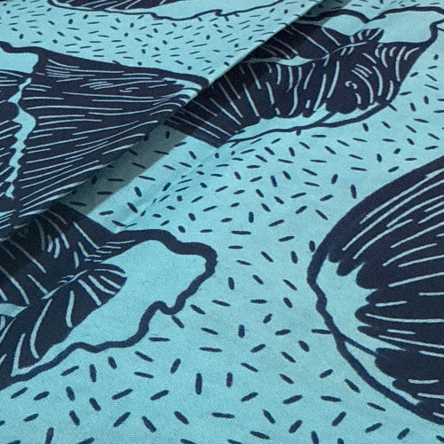 Fabric with black abstract patterns on a light blue background