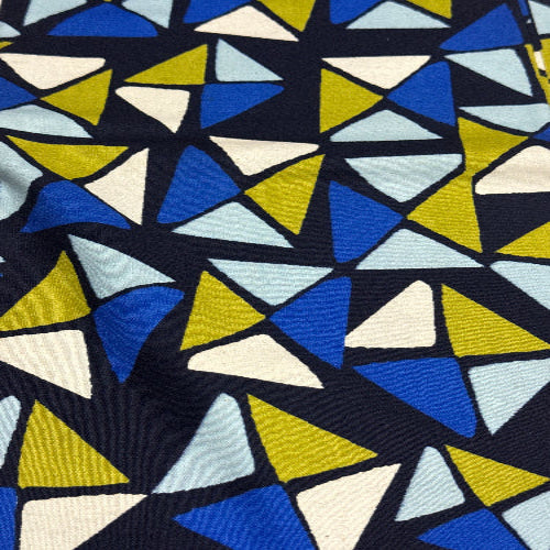Geometric pattern of triangles in blue, yellow, and white on a dark background