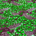 Patterned fabric with black dragons on a green background