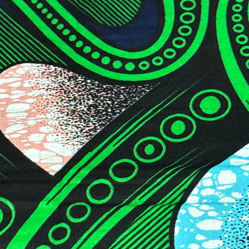 Close-up of fabric with green circular patterns on a black background