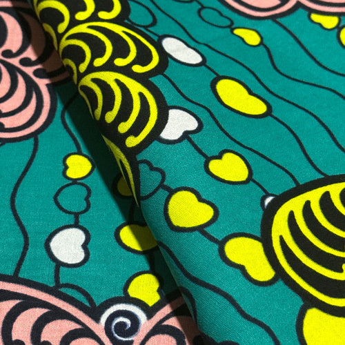 Close-up of colorful fabric with abstract patterns on a teal background