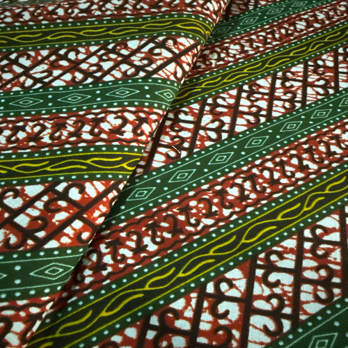 Close-up of patterned fabric with green, red, and white colors.