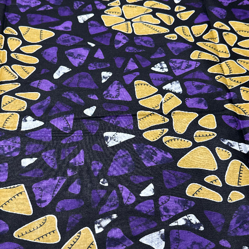 Patterned fabric with yellow and purple shapes on a black background