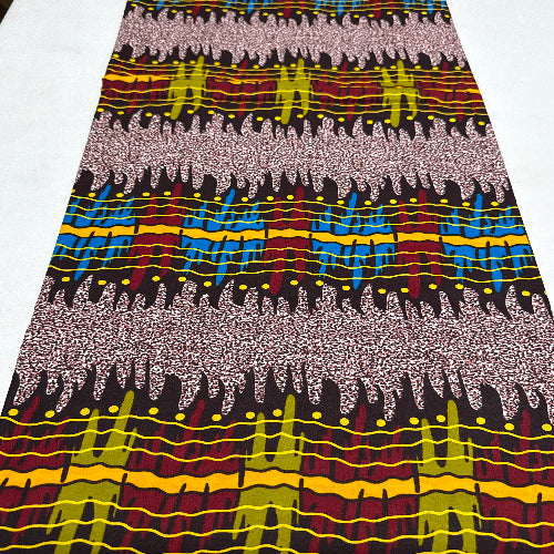 Close-up of a colorful fabric with a pattern of wavy lines and geometric shapes.