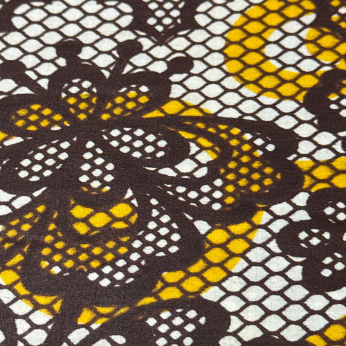Close-up of a fabric with a black and yellow floral pattern on a white background