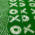 Green fabric with white 'XOXO' pattern