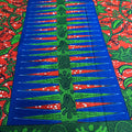 Colorful fabric with blue, green, and red patterns on a red background