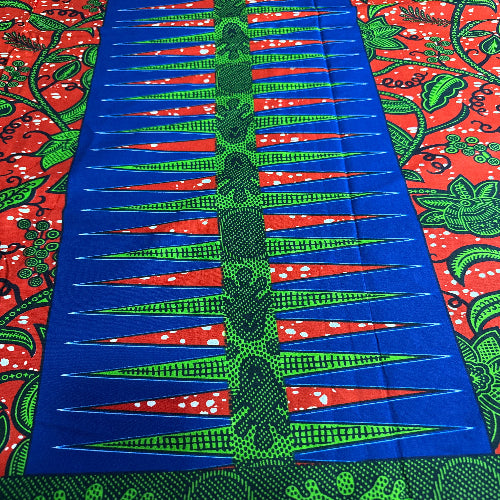 Colorful fabric with blue, green, and red patterns on a red background