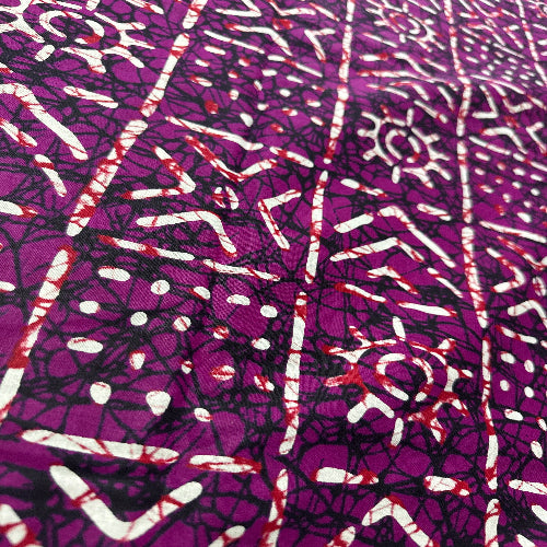 Purple fabric with white and red abstract pattern