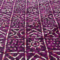 Purple fabric with white geometric patterns