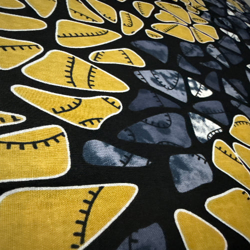 Close-up of a fabric with yellow and gray abstract pattern