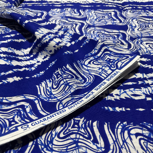 Blue and white patterned fabric with a visible brand label.
