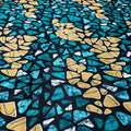 Patterned fabric with blue and yellow shapes on a black background