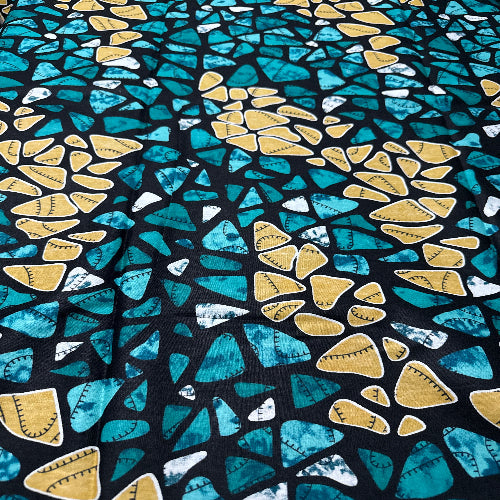 Patterned fabric with blue and yellow shapes on a black background